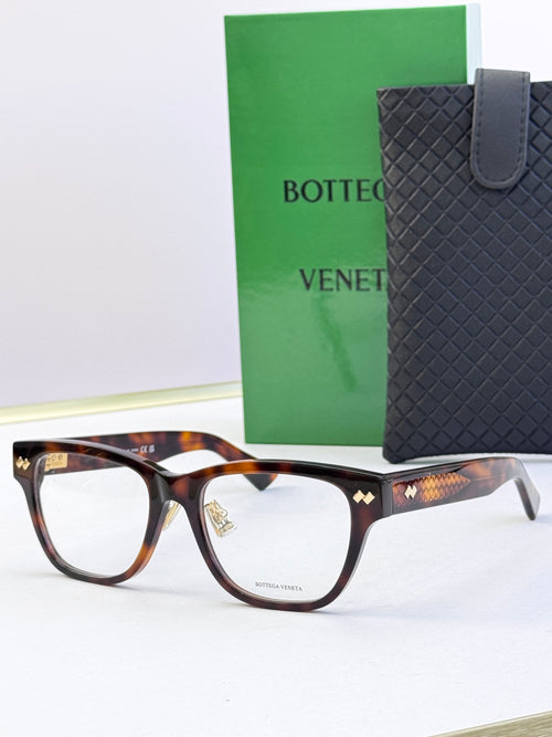 Tortoiseshell eyeglasses with gold temple detail and rectangular clear lenses.