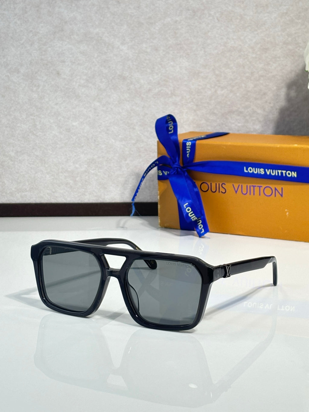 Sunglasses with black square frames and dark tinted lenses