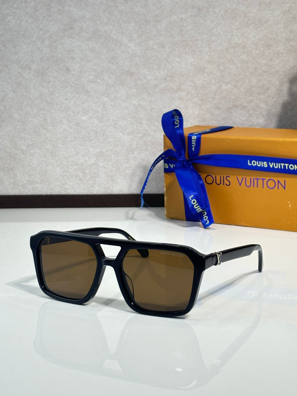 Sunglasses with black square frames and brown tinted lenses