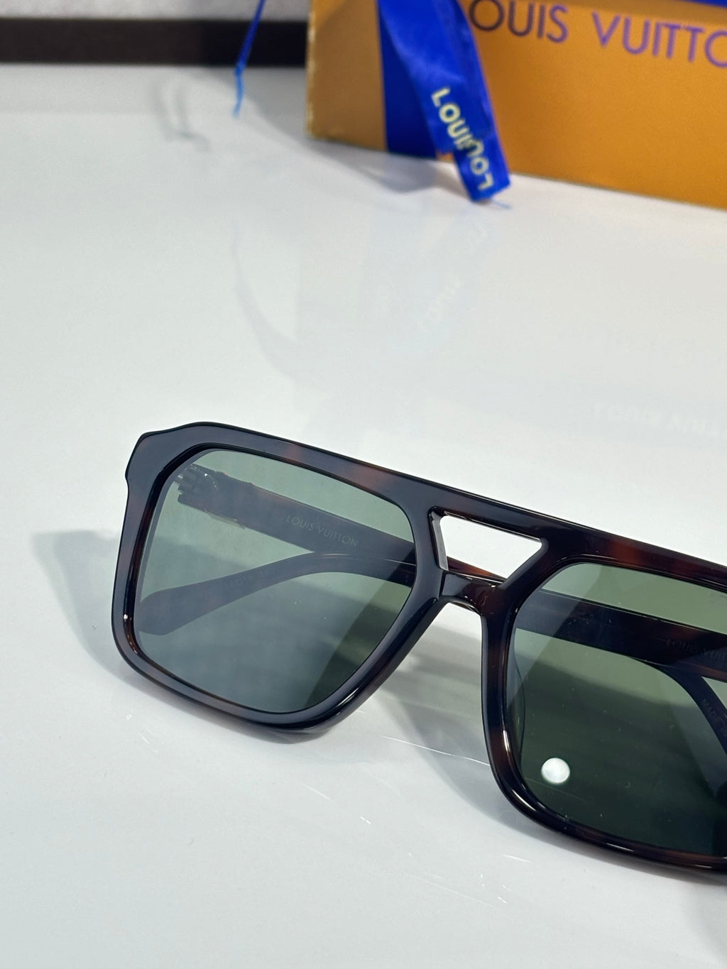 Sunglasses close-up with dark lenses and burgundy tortoiseshell temple tips