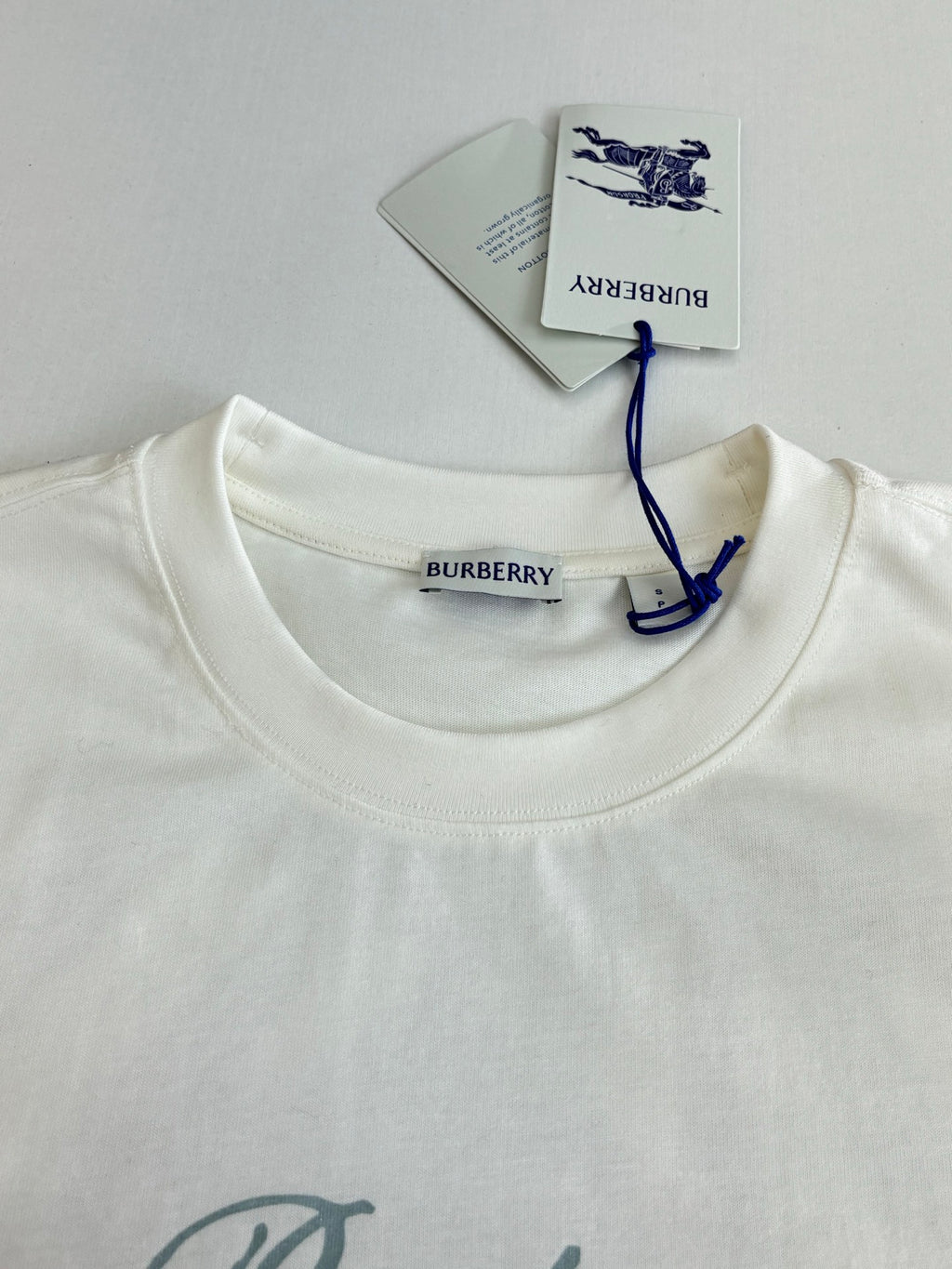 Burberry white T-shirt neckline with brand label and blue bow tag