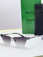 Bottega Veneta sunglasses with dark frame and cool gray gradient lenses