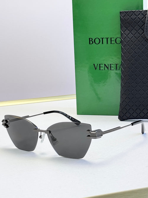 Bottega Veneta sunglasses with dark gray lenses, light gray frame and gold accents