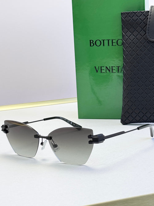 Bottega Veneta sunglasses with dark gray lenses, black frame and gold accents