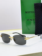 Bottega Veneta sunglasses with gold frame and dark gray gradient lenses