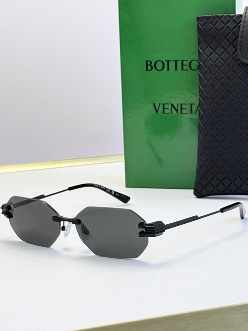 Bottega Veneta sunglasses with black frame and light gray tinted lenses, octagonal shape.