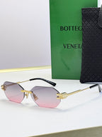 Bottega Veneta sunglasses with gold frame and pink tinted lenses, octagonal shape.