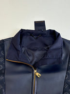 Navy jacket close-up with gold-tone zipper and interior lining pocket
