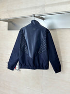 Navy stand-collar zip jacket with monogram panels on sleeves and back