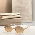 Bvlgari round sunglasses with gold-tone frame and clear gradient lenses