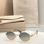 Bvlgari round sunglasses with gold-tone frame and blue-gray tinted lenses