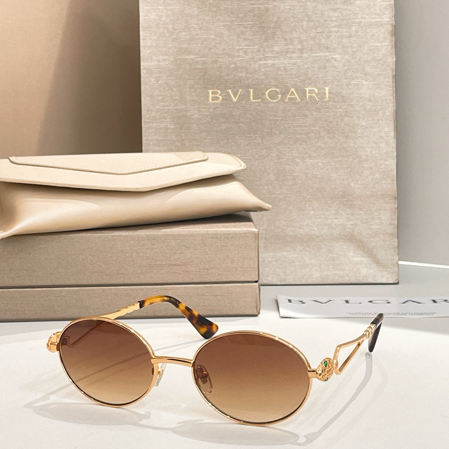Bvlgari round sunglasses with gold-tone frame and tortoiseshell temple arms