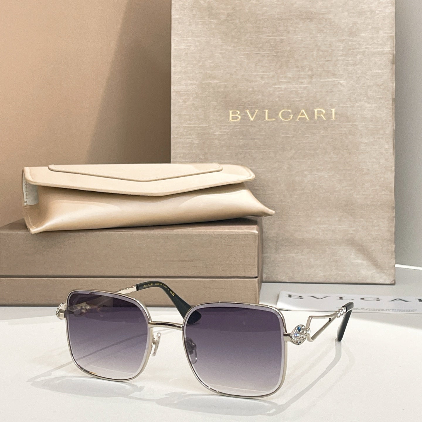 Bvlgari sunglasses with dark purple lenses and silver frame, square style