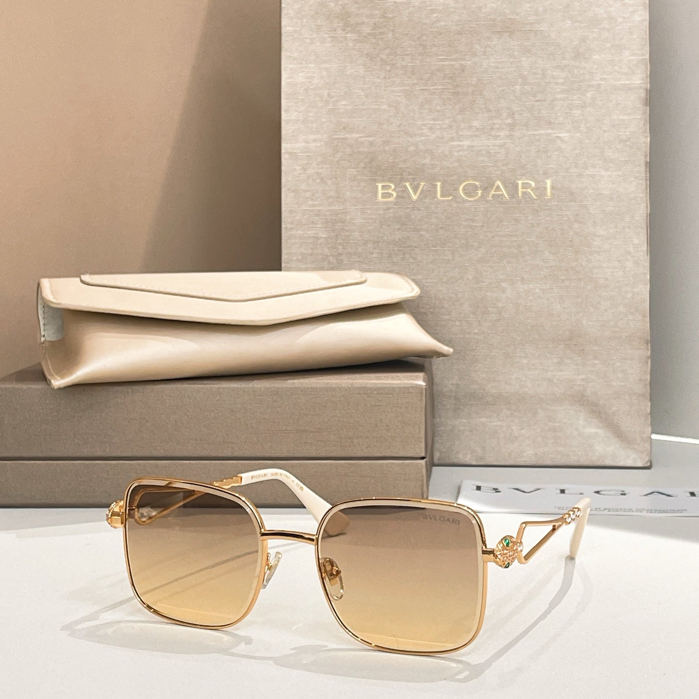 Bvlgari sunglasses with amber lenses and gold frame, square style