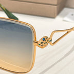 Bvlgari sunglasses close-up: gold frame with jeweled hinge and blue lens