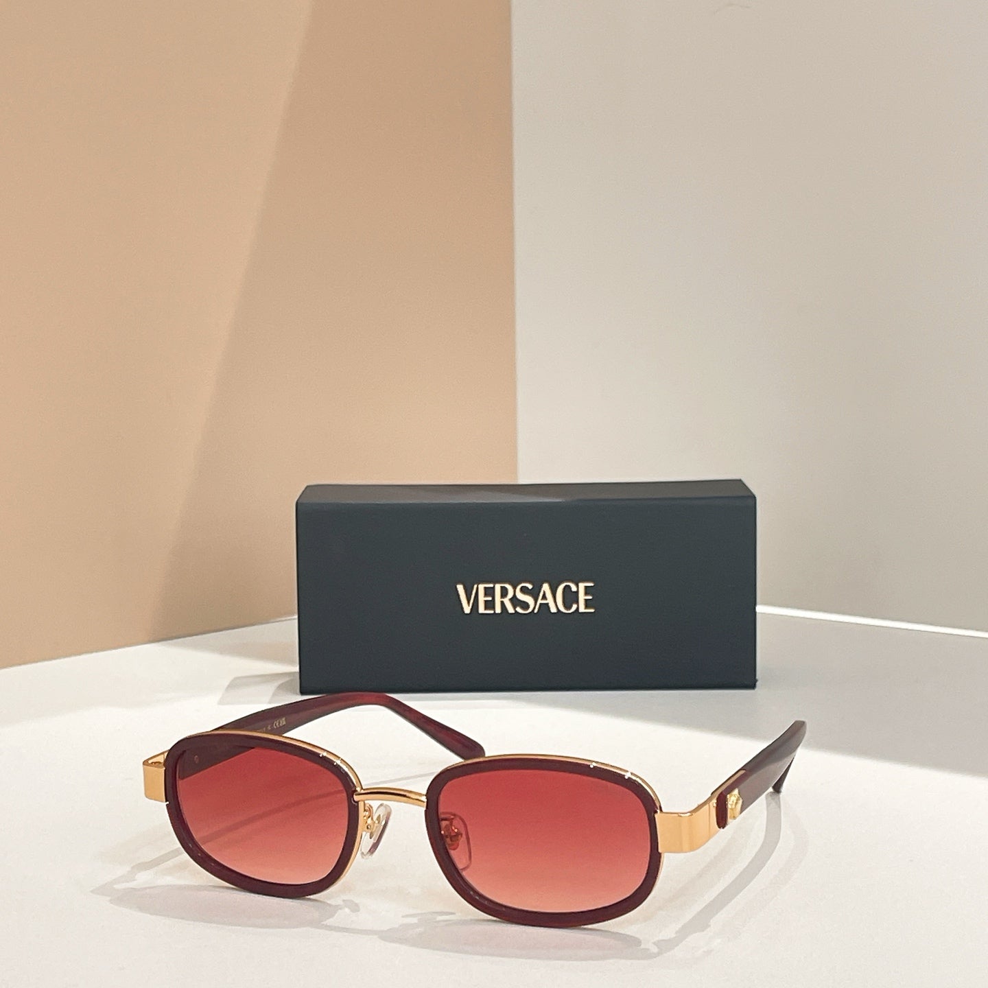 Versace sunglasses, gold frames with burgundy-red tinted lenses