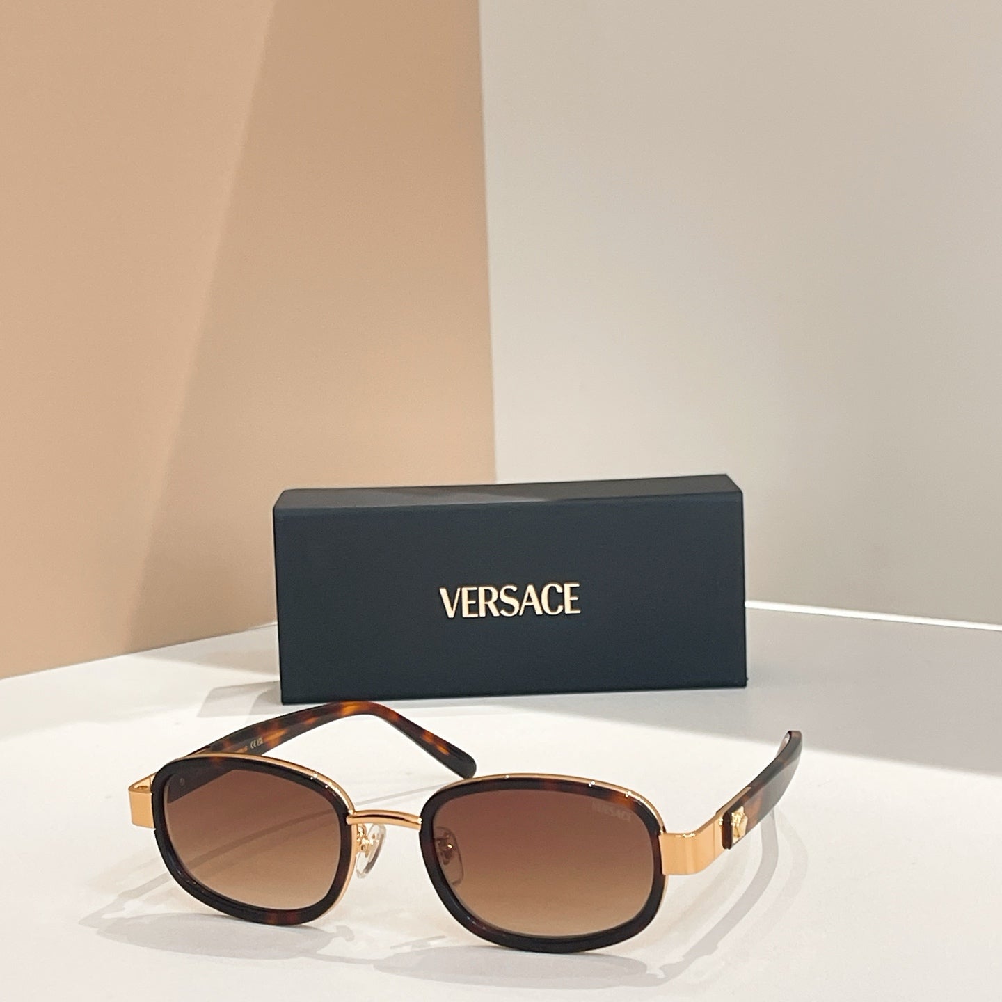 Versace sunglasses, black frames with gold rims and brown-tinted lenses