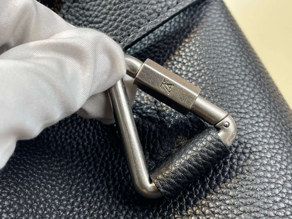 Louis Vuitton bag close-up of metal clasp on textured leather