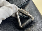 Louis Vuitton bag close-up of metal clasp on textured leather