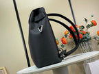Louis Vuitton bag angled view, dark leather with top handle and long shoulder strap