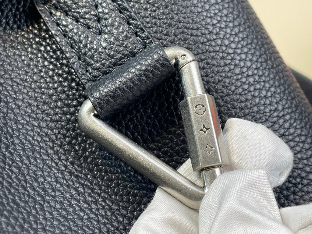 Louis Vuitton bag close-up of metal snap hardware and strap connection