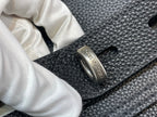 Louis Vuitton bag close-up of engraved metal buckle with logo on leather strap