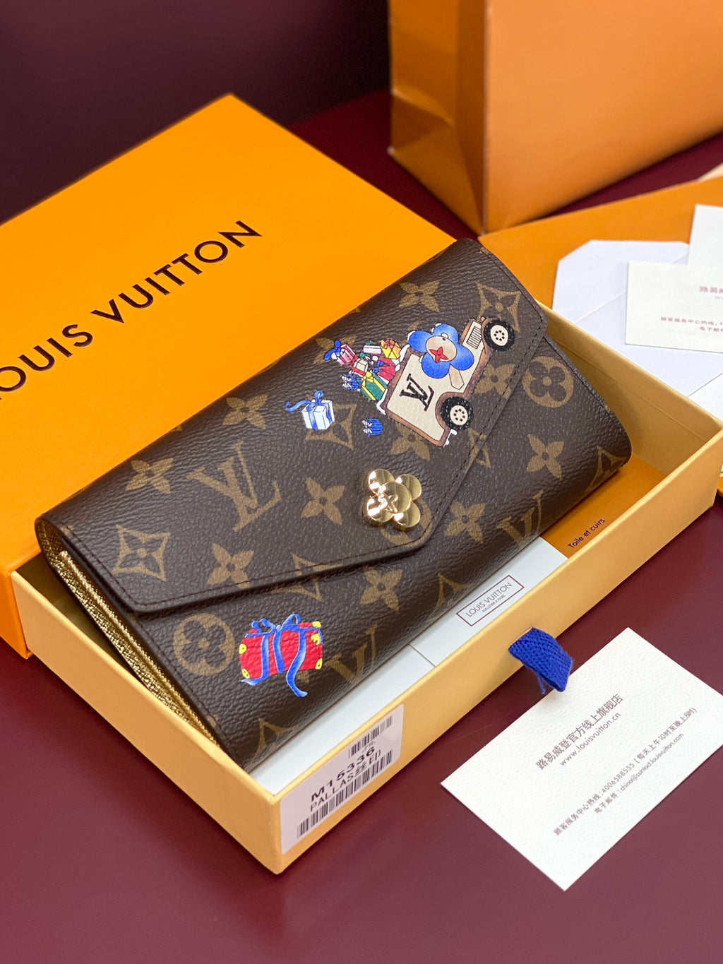 Louis Vuitton small bag with brown monogram canvas and colorful charm patches, flap front.
