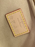 Leather brand patch on tan lining with flower stamp and stitched border