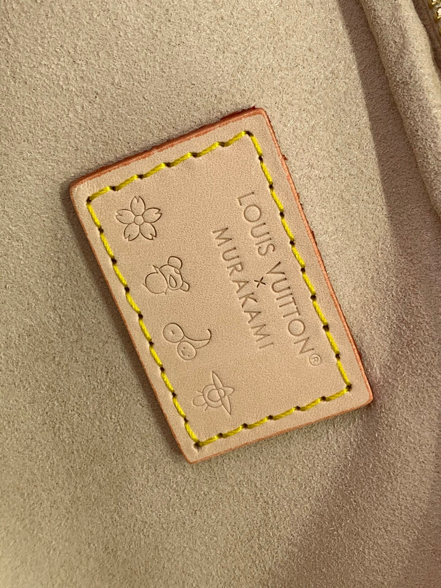 Leather brand patch on tan lining with flower stamp and stitched border