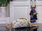 Designer top-handle bag, white with multicolor monogram pattern, gold strap hardware