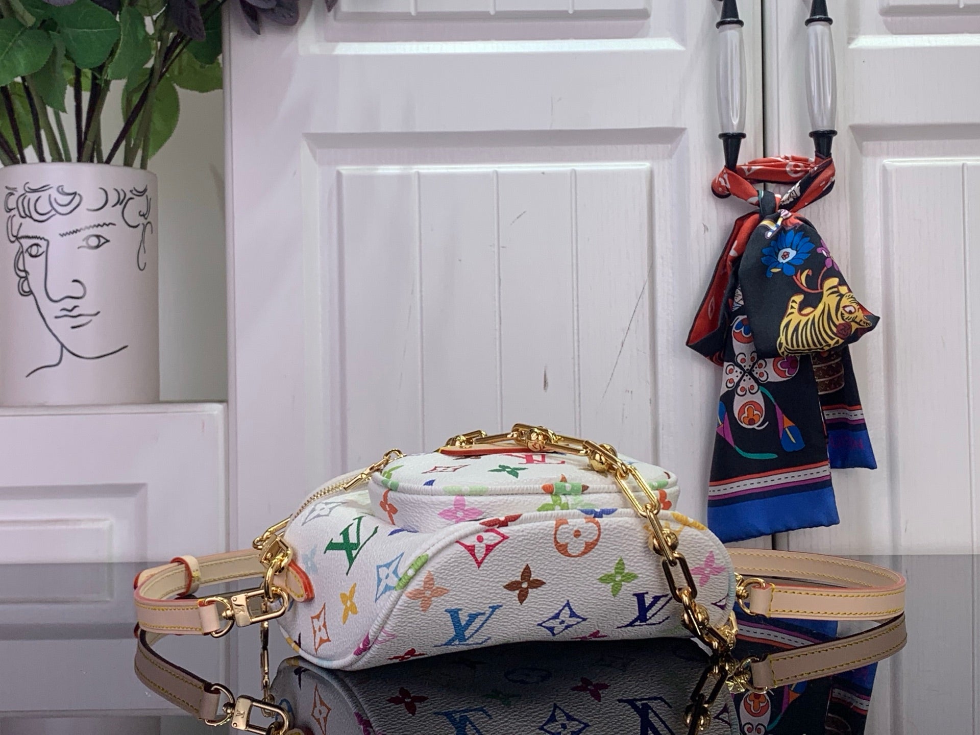Designer top-handle bag, white with multicolor monogram pattern, gold strap hardware