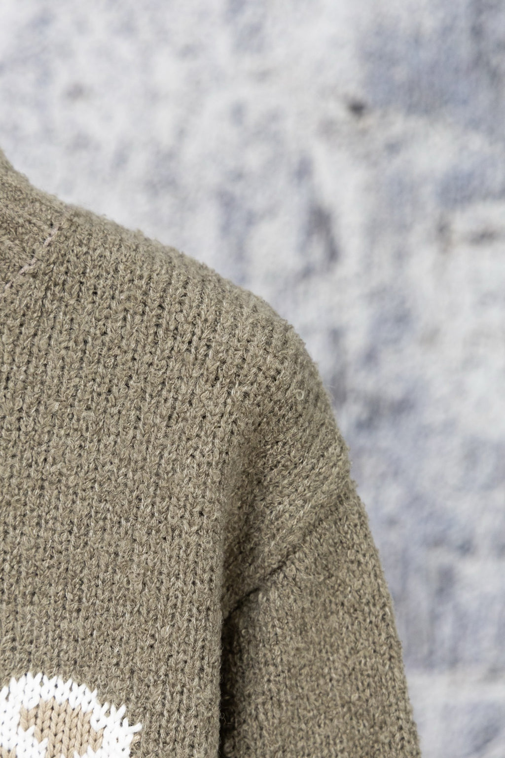 Khaki knit sweater shoulder seam close-up