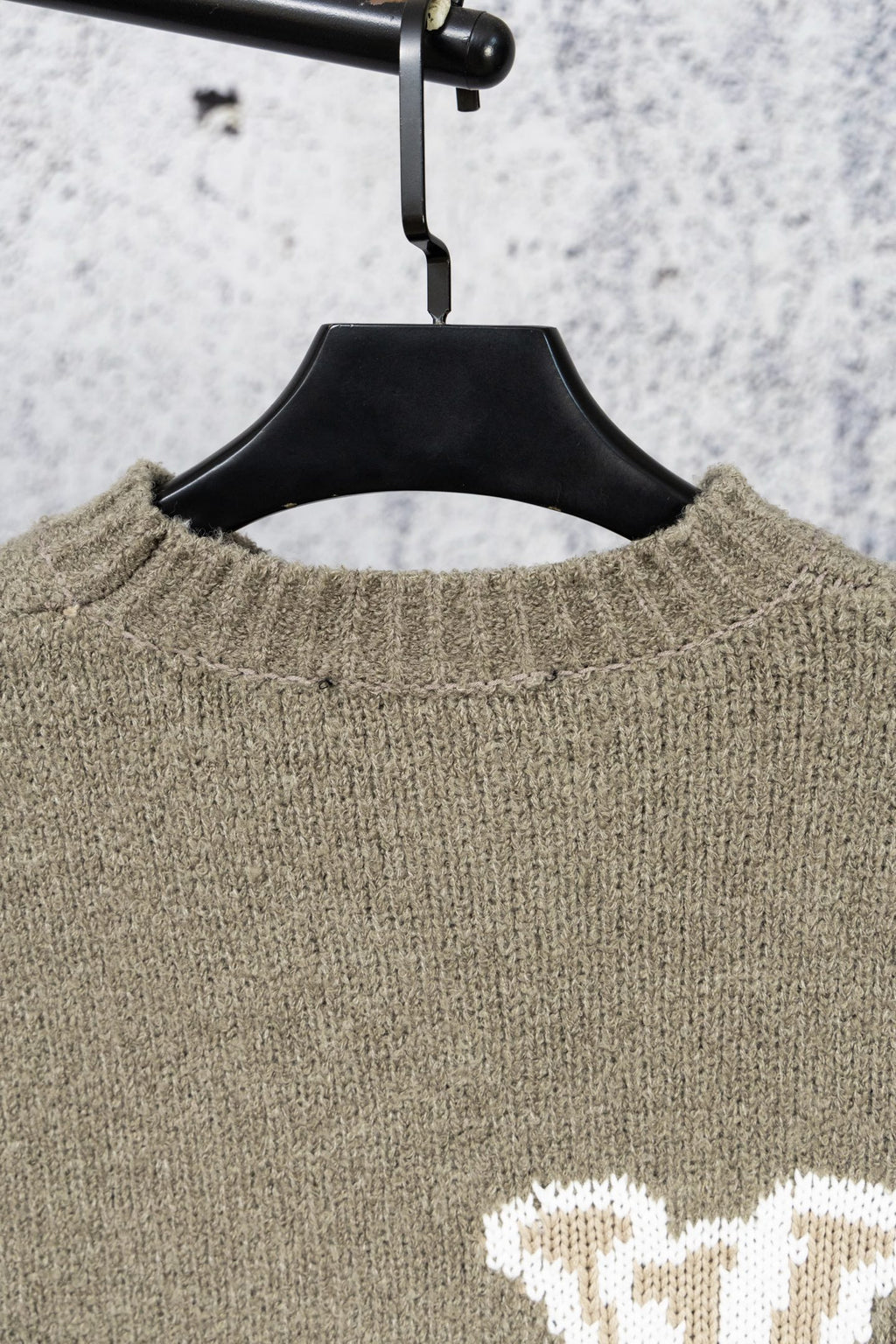 Khaki knit sweater neckline with ribbed collar detail