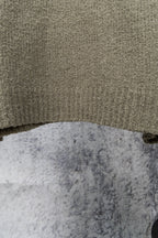 Khaki knit sweater hem and textured fabric close-up
