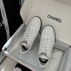 Chanel unisex sneakers, top view of white leather uppers with quilted panels and laces