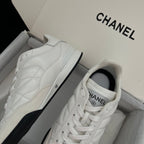 Chanel unisex sneakers, side view of white leather upper with stitched overlays