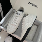 Chanel unisex sneakers pair in box, white leather with quilted panel and black sole trim