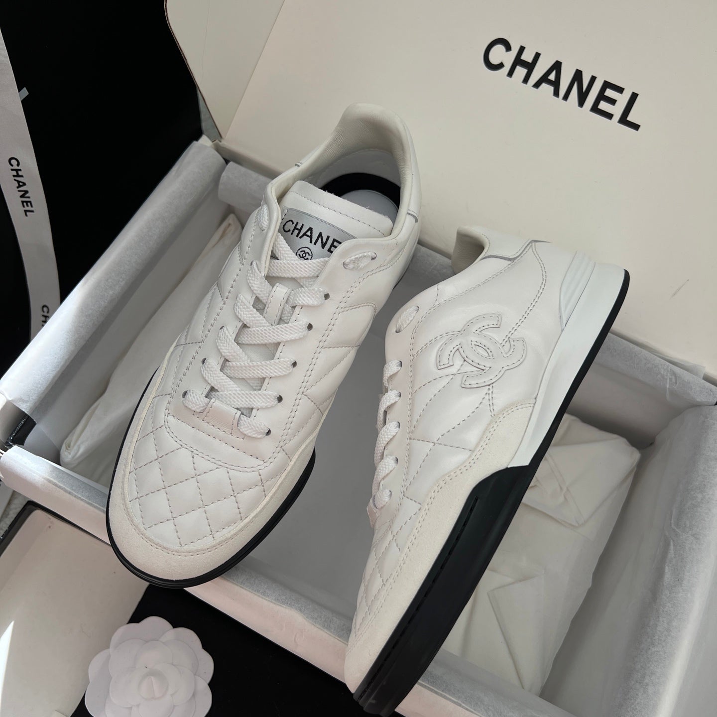 Chanel unisex sneakers pair in box, white leather with quilted panel and black sole trim