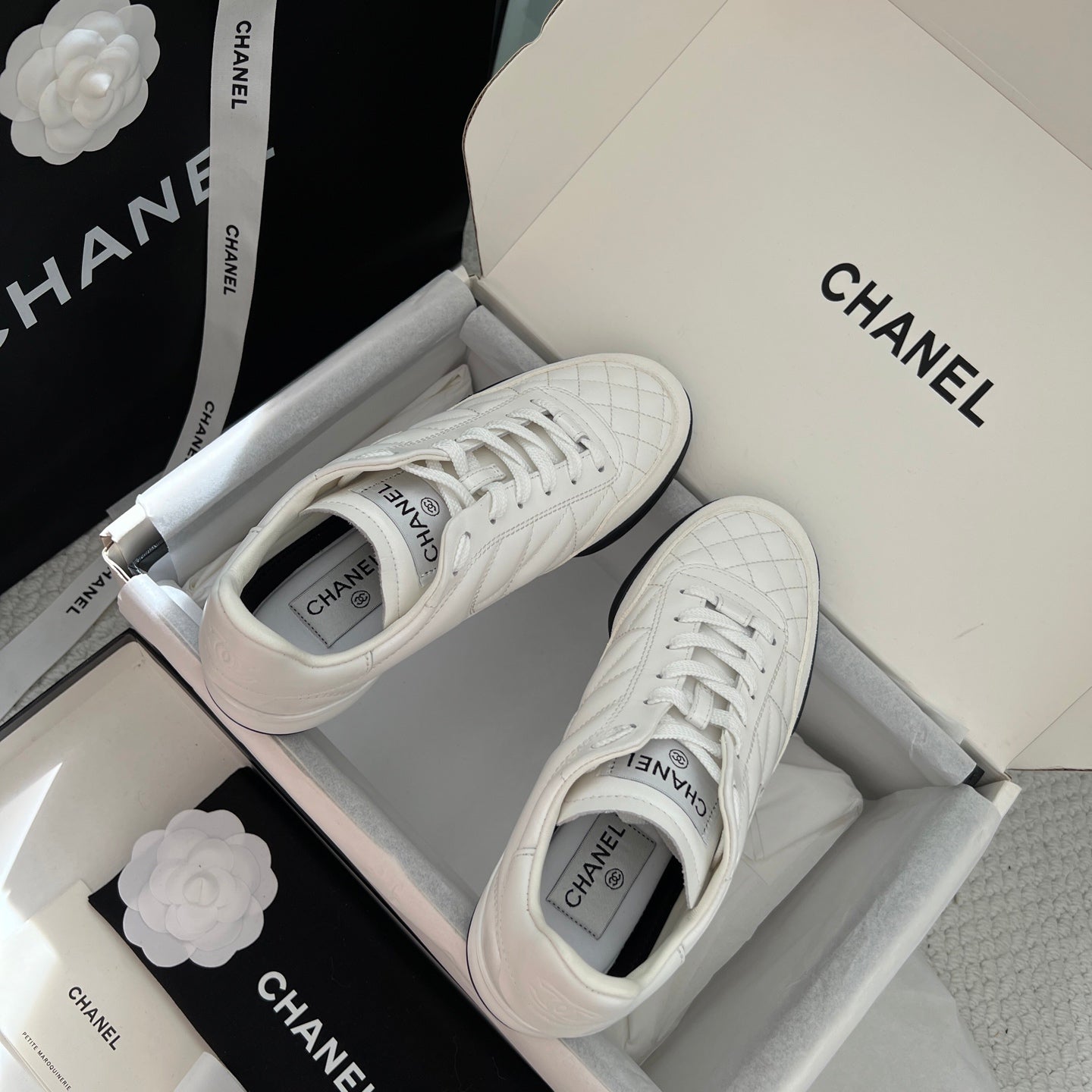 Chanel unisex sneakers in box, white quilted toe and white laces with logo on heel
