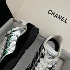 Pair of low-top sneakers with metallic silver uppers, black panels, white laces