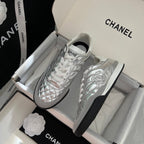 Chanel metallic sneakers with quilted panels, white laces, and black sidewall