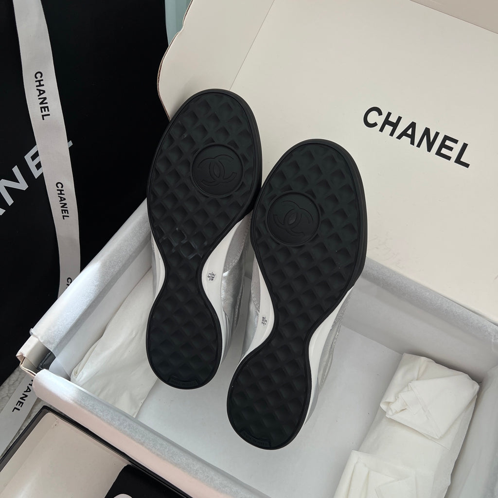 Chanel sneaker outsoles with dark tread pattern and raised CC emblem