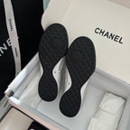 Chanel sneaker outsoles with dark tread pattern and raised CC emblem