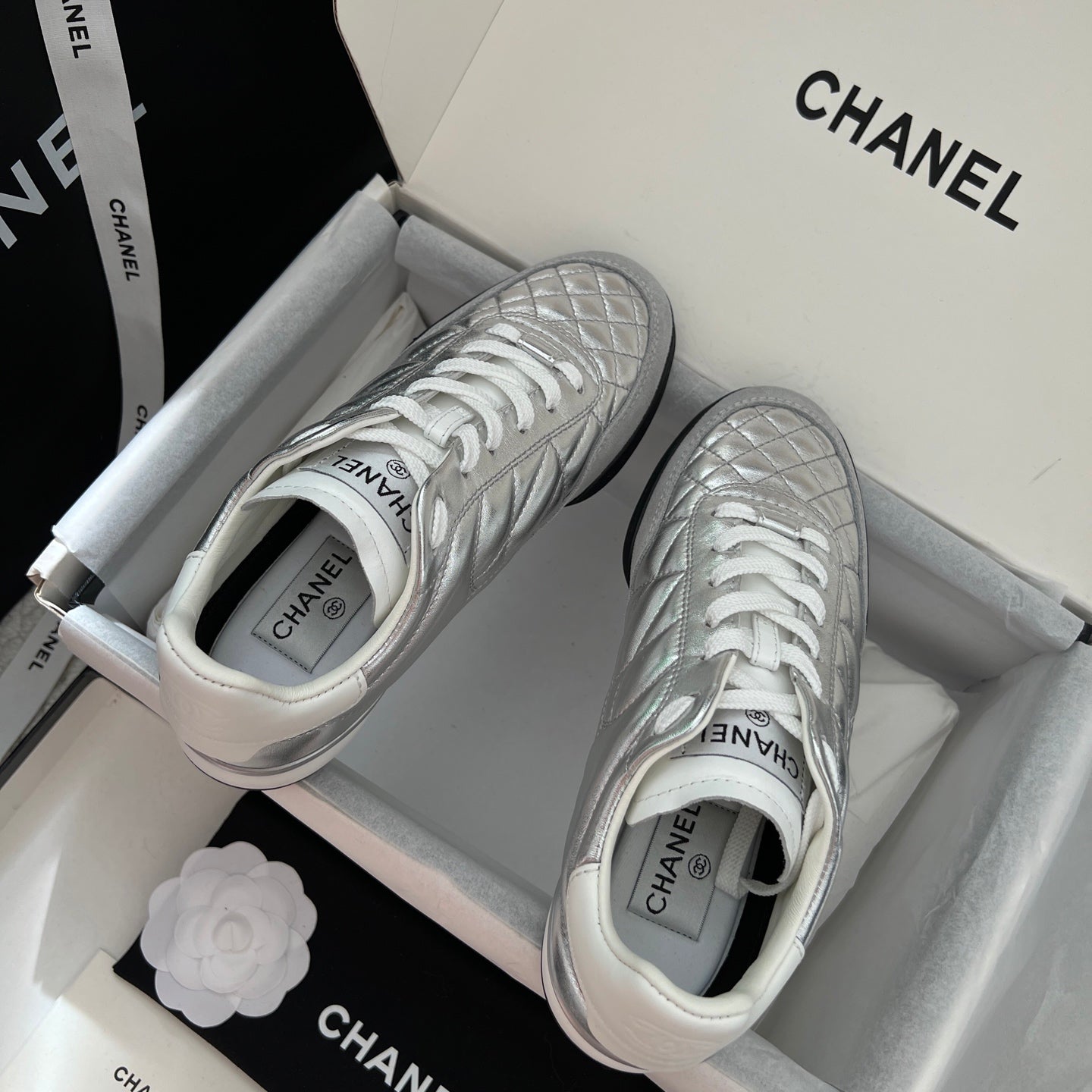 Chanel metallic sneakers with white midsoles and quilted side panels, lace-up
