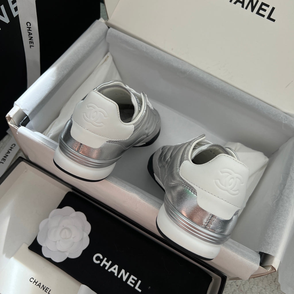 Chanel sneakers: back view with silver heel logo and white rubber soles