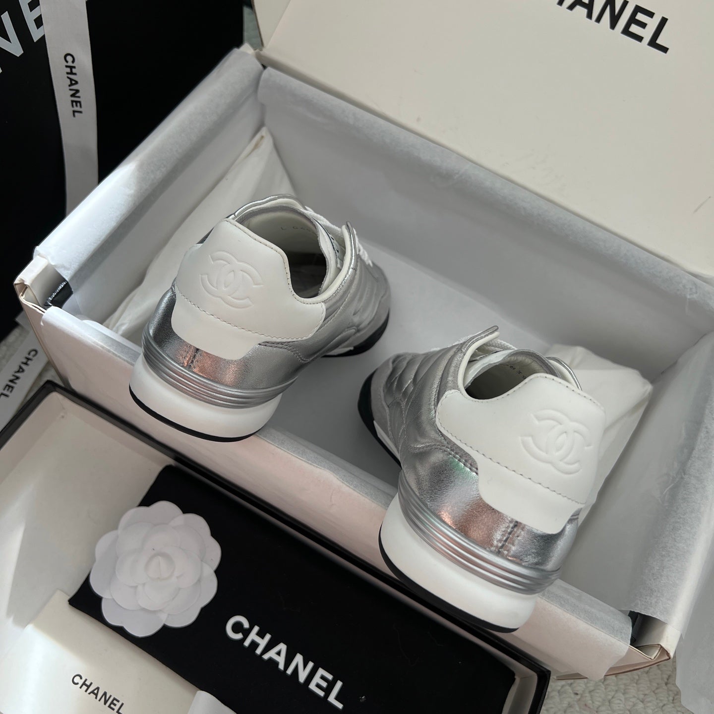 Chanel sneakers: back view with silver heel logo and white rubber soles