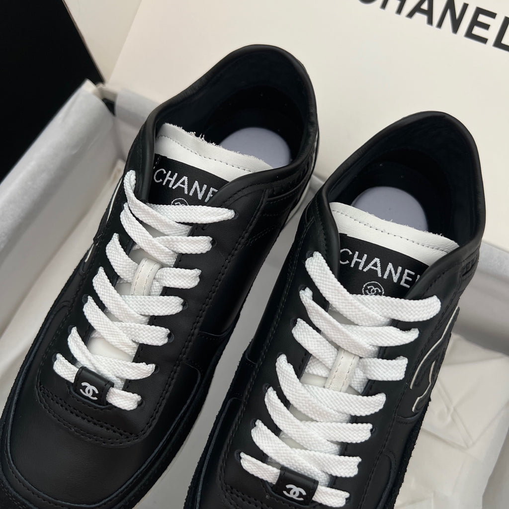 Chanel unisex black leather sneakers with white laces and CHANEL logo tongue
