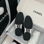 Chanel unisex black sneaker soles with CHANEL logo, pair in shoebox