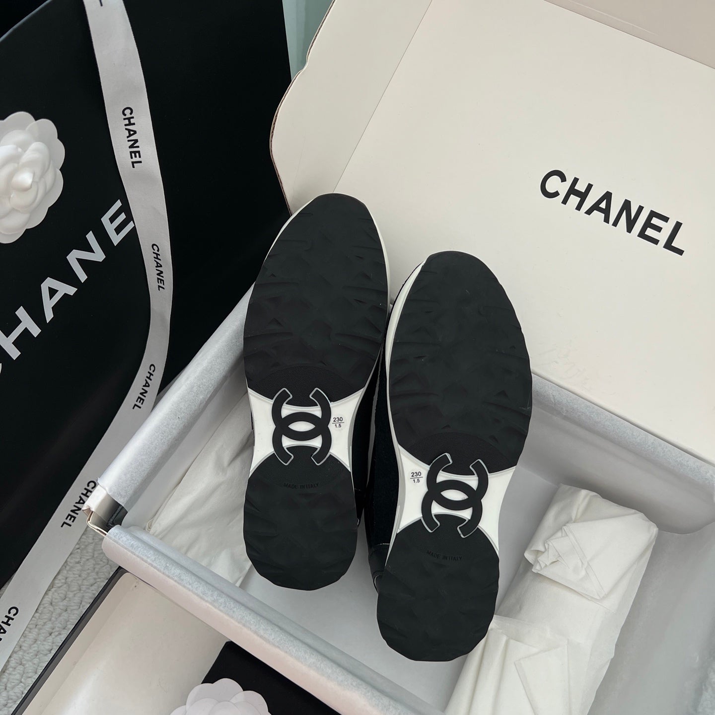 Chanel unisex black sneaker soles with CHANEL logo, pair in shoebox