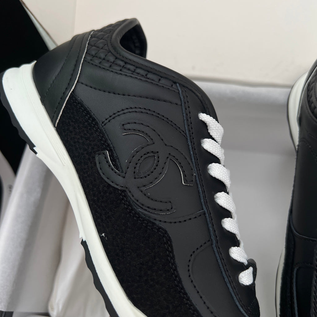 Chanel unisex black leather sneaker with front logo embroidery and white laces